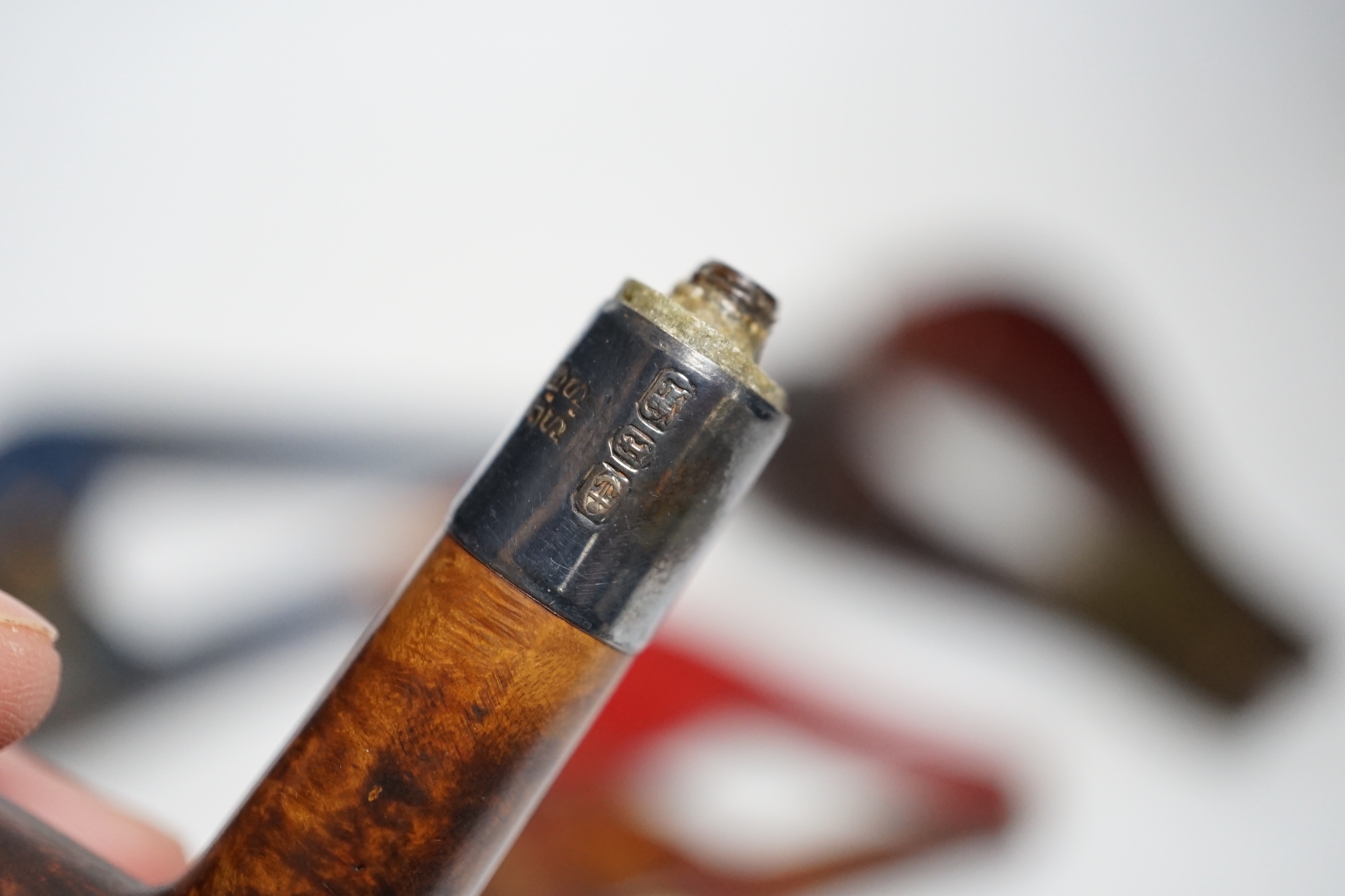 Three cased pipes, one with carved amber novelty bowl, the other two with amber pipe ends, metal mounted, together with a tortoiseshell and mother of pearl card case, Card case 10.5cm high x 8cm wide